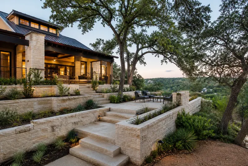 Terraced limestone garden steps below a hillside home