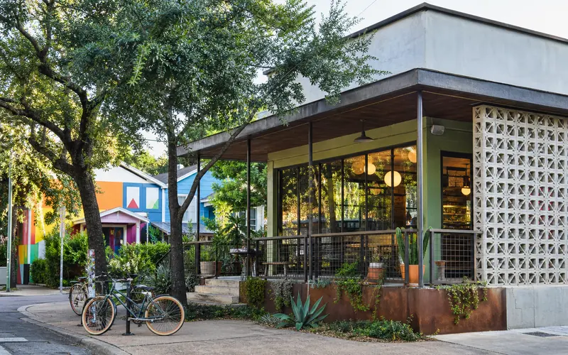 Shaded cafe corner on an Austin neighborhood street