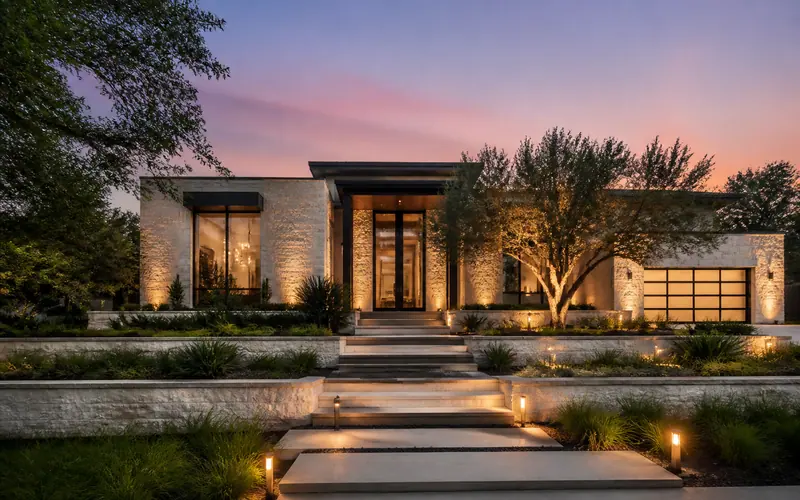 Modern home at twilight with a lit stone path