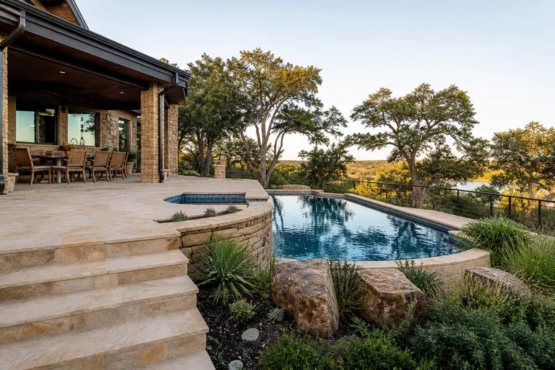 Stone steps down to a pool with Hill Country views